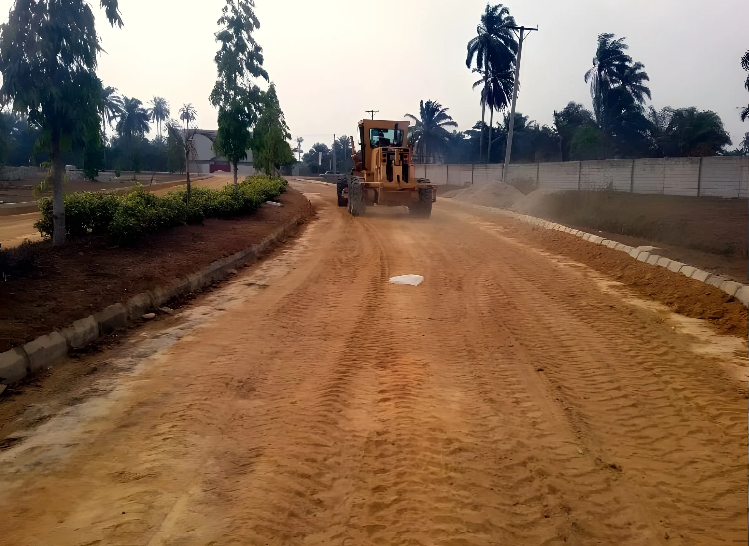 Grader shaping a new estate road