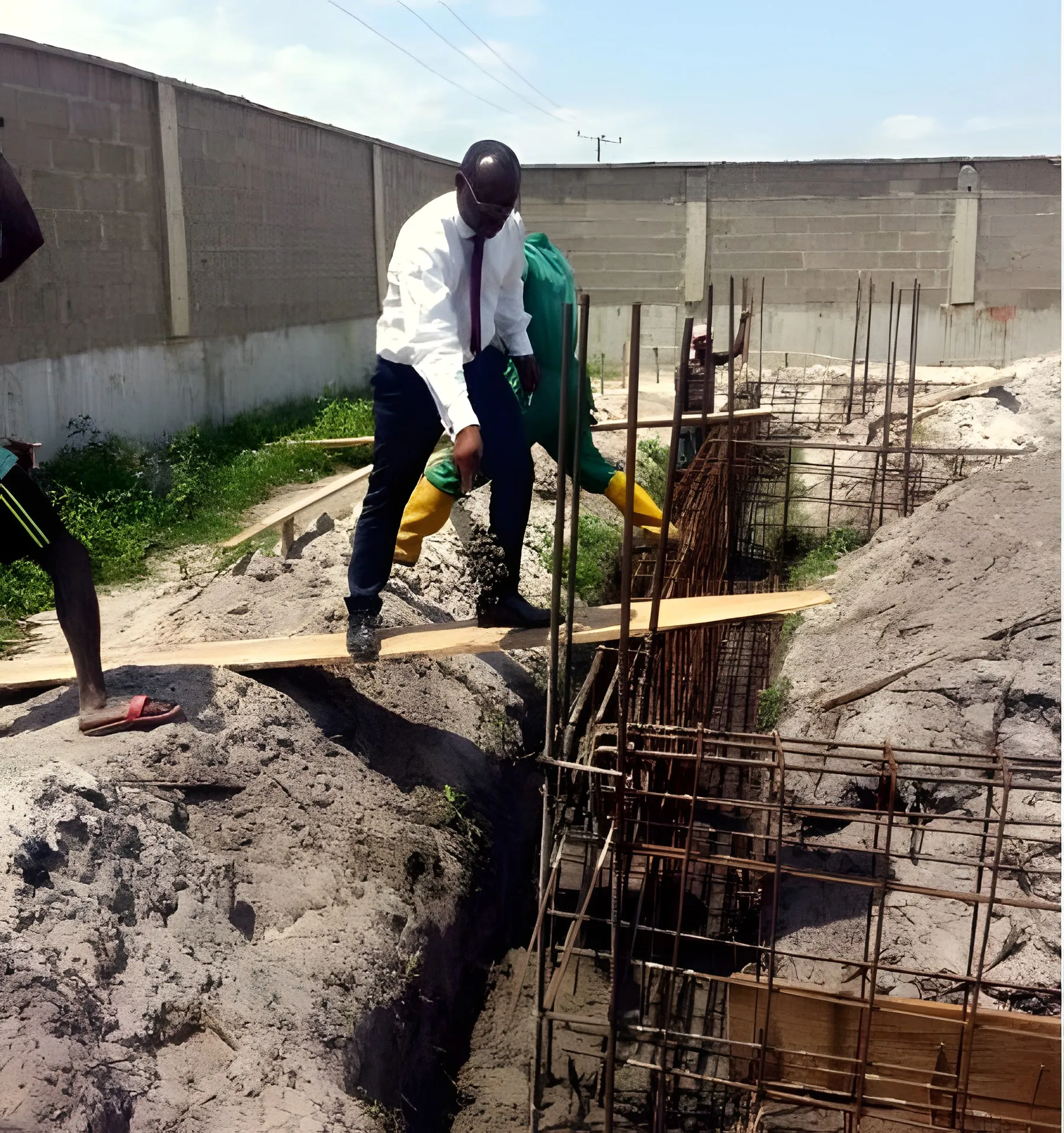 Site progress · Site engineer inspecting footings