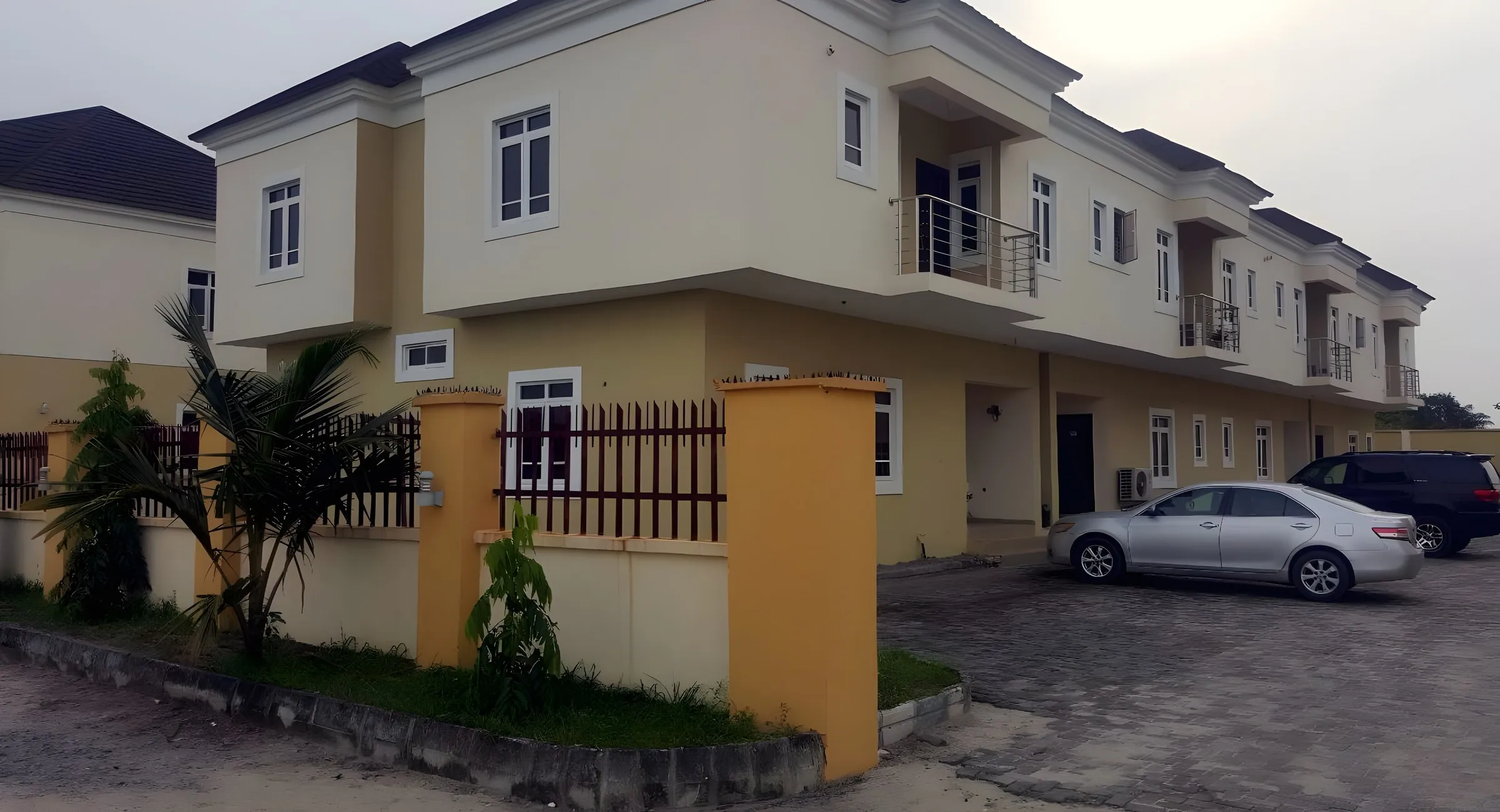 Finished cream terrace duplexes on a paved close in LivingspringCourts-1